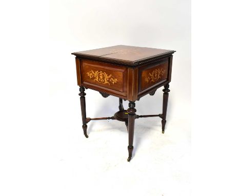 An early 19th century rosewood and floral marquetry inlaid 'Eclipse' drinks cabinet, the moulded edge enclosing a lifting com