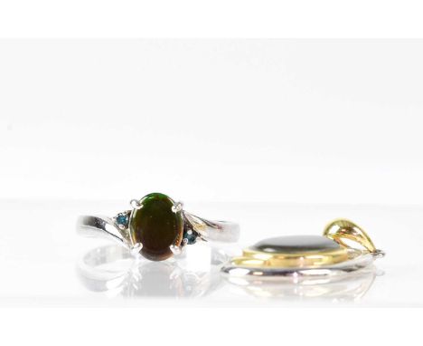 A 14ct white gold ring set with opal, size N, approx. 2.5g, and an opal set pendant, both marked 14k (2). 