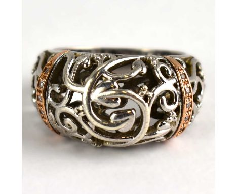 CLOGAU; a silver, rose gold and diamond ring from the 'Am Byth' collection, with openwork naturalistic top, with two bands of