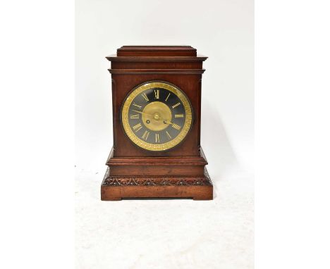 An early 20th century mahogany cased mantel clock, the brass and painted dial set with Roman numerals, in an architectural ca