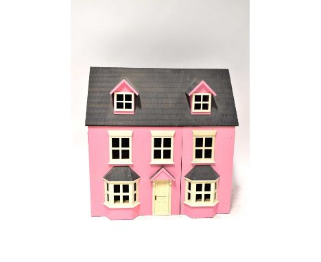 A pink Georgian-style doll's house with tile-effect roof, height 62cm, width 62cm, together with a quantity of plastic doll f