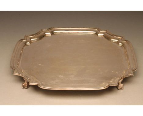 A SQUARE SILVER SALVER, maker Walker &amp; Hall, Sheffield 1944, with re-entrant corners and pie-crust rim raised upon four c