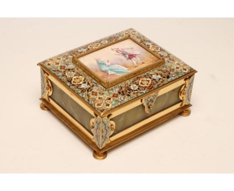 A FRENCH NAPOLEON III STYLE ORMOLU, CHAMPLEVE ENAMEL AND ONYX CASKET, of plain oblong form, the hinged cover centred by a pan