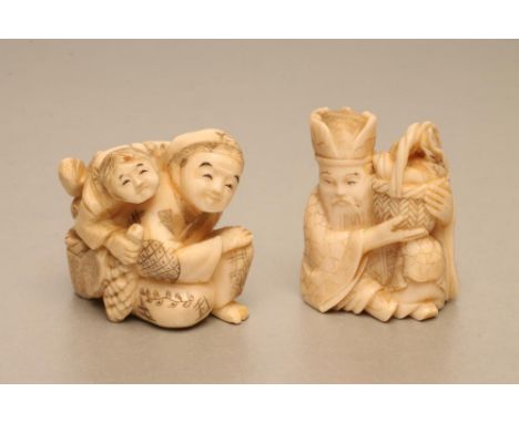 TWO JAPANESE IVORY NETSUKE, one carved as a seated male with a small boy on his back, 1 1/2" high, the other as a seated male