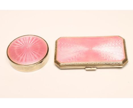 AN ART DECO SILVER COMPACT, maker's mark EBR, London import marks 1926, the plain cylindrical box with pink guilloche enamel 