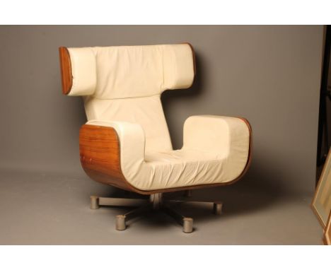 A MOULDED VENEERED ROSEWOOD ARMCHAIR with shaped cream leather cushion, waisted raked back with deep curved head rest, down-t