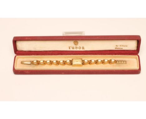 A LADY'S GOLD ZENITH WRISTWATCH, the silvered oblong dial with applied gilt metal Arabic quarter numerals, the jewelled movem