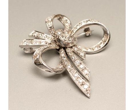 A DIAMOND BOW BROOCH, the triple loop and five tails millegrain set with numerous graduated round brilliants (Est. plus 21% p