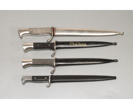 FOUR GERMAN MINIATURE SOUVENIR BAYONETS,1918-1945, all with metal scabbards, one paint inscribed "Coblenz" to the scabbard (E