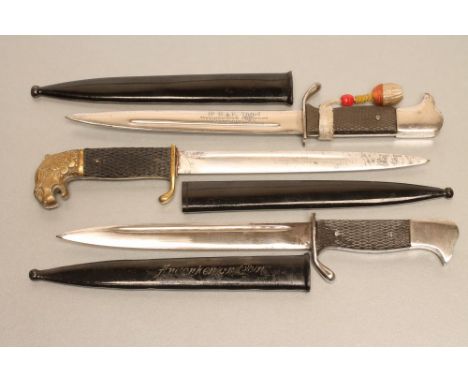 THREE GERMAN MINIATURE SOUVENIR BAYONETS,1918-45, comprising an M.98 bayonet with metal scabbard inscribed "Andenken an Coln"