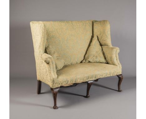 A GEORGIAN MAHOGANY WING BACK SOFA, second quarter 18th century, upholstered in a pale green and gold weave, straight top rai