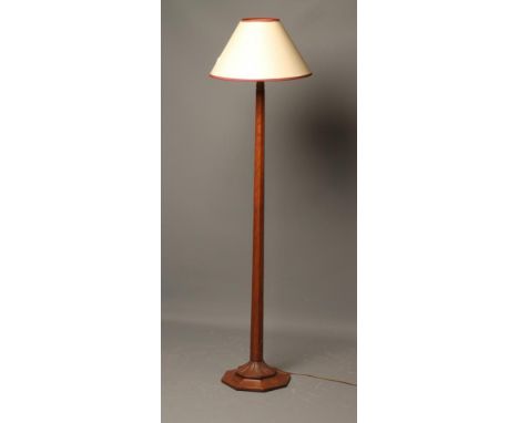 AN OAK STANDARD LAMP by Martin Dutton, the tapering octagonal stem with carved stiff leaf collar, carved lizard trade mark in