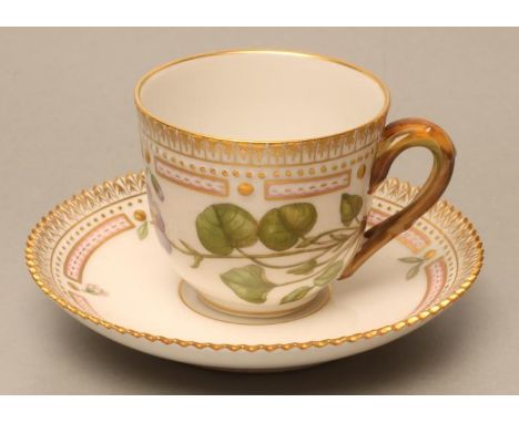 A ROYAL COPENHAGEN PORCELAIN FLORA DANICA COFFEE CUP AND SAUCER, painted in polychrome enamels with "Viola Muhlen Bergiana Ho