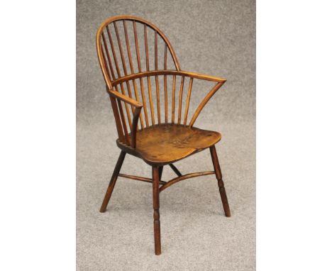 A GILLOW TYPE STICK BACK WINDSOR ARMCHAIR, c.1800, in ash and elm with low hoop back, curved arm supports, saddle seat, raise