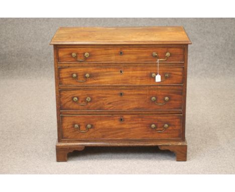 A GEORGIAN SMALL MAHOGANY CHEST, late 18th century, the moulded edged top over four graduated cockbeaded drawers with brass d