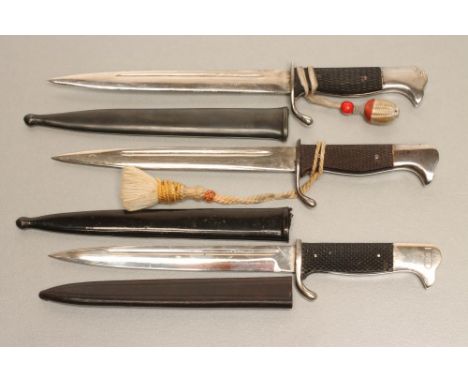 THREE GERMAN SOUVENIR MINIATURE BAYONETS,1918-45, two with metal scabbards and officer's knots, the third with a good quality