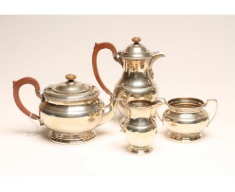 A SILVER FOUR PIECE TEA AND COFFEE SERVICE, maker Adie Bros. Ltd., Birmingham 1941, of squat baluster form with rosette cast 