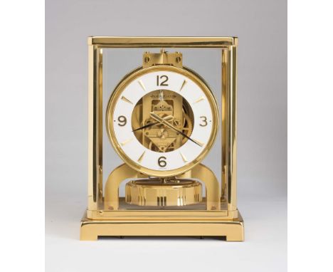 A JAEGER-LECOULTRE ATMOS CLOCK, the skeletonised movement with rotating pendulum numbered 553553, 4 1/4" white chapter ring w