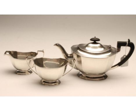 A SILVER THREE PIECE TEA SERVICE, maker Frank Cobb, Sheffield 1935, of canted rounded oblong form on a swept foot, all engrav