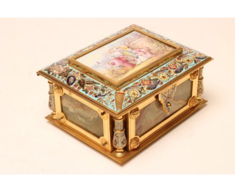 A FRENCH NAPOLEON III STYLE ORMOLU, CHAMPLEVE ENAMEL AND ONYX CASKET, of plain oblong form, the hinged cover centred by a pan
