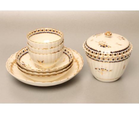 A CAUGHLEY PORCELAIN PART TEA SERVICE, c.1780, painted in underglaze blue and highlighted in gilt with scattered sprigs withi