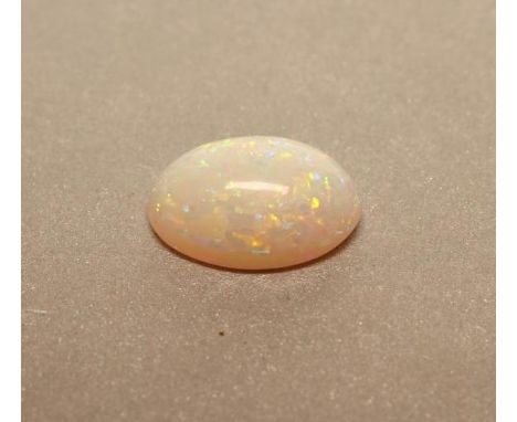 AN UNMOUNTED OPAL, the oval cabochon polished stone of approximately 2.25cts (Est. plus 21% premium inc. VAT)