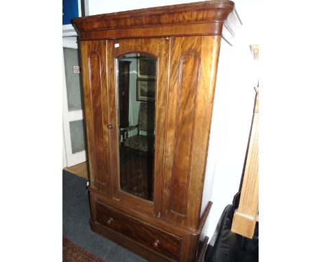 A Victorian Mahogany Wardrobe with mirror door and drawer below