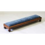 A LONG MAHOGANY FOOTSTOOL with blue padded top.