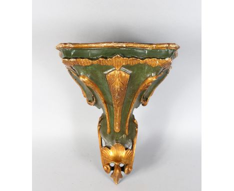 A CARVED WOOD AND GILDED BRACKET. 13ins high.