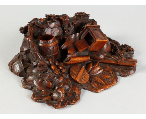 A BLACK FOREST CARVED OAK INKSTAND, barrel, lamp, chain etc. 11ins long.