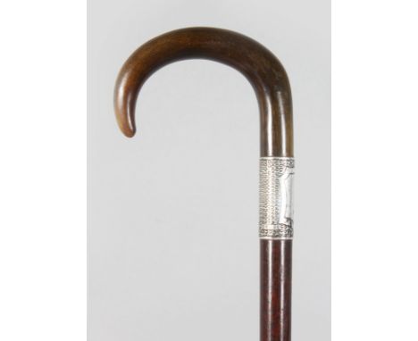 A HORN HANDLED WALKING STICK, with silver collar. 33ins long.