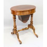 A VICTORIAN FIGURED WALNUT OVAL WORK BOX with plain rising top, fitted interior, turned and carved