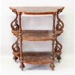 A GOOD VICTORIAN FIGURED WALNUT SHAPED FRONT THREE TIER WHAT-NOT, with turned and pierced support,
