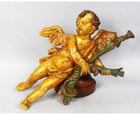 AN 18TH CENTURY ITALIAN CARVED WOOD AND GILDED CUPID on a bracket.