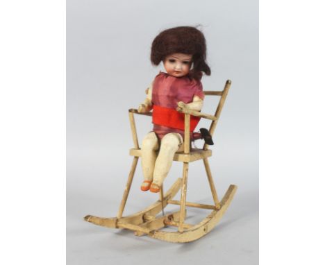AN UNUSUAL LATE 19TH CENTURY GERMAN AUTOMATON, of a doll in a rocking chair. 10ins high.