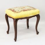 A VICTORIAN MAHOGANY CABRIOLE LEG STOOL, with needlework top.