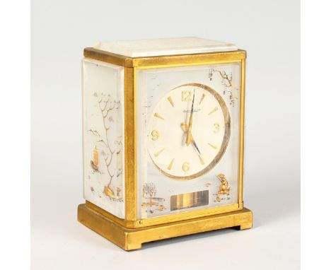 A GOOD LUCITE ATMOS CLOCK, JAEGER LECOULTRE, with Chinese designs. 9ins high, in original box.