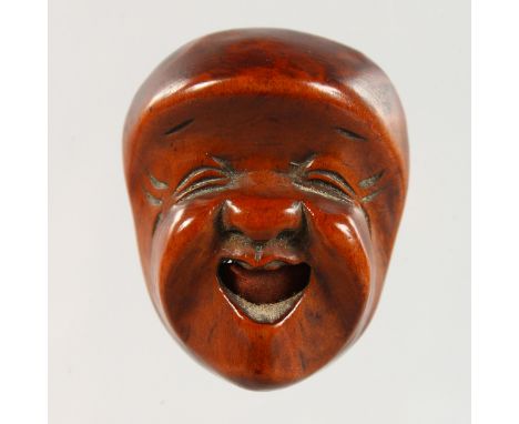 A  JAPANESE CARVED BOXWOOD NETSUKE MASK.