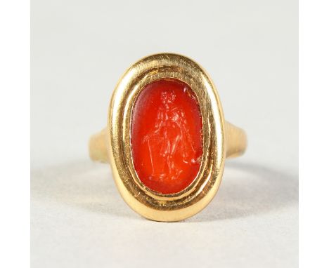 AN EARLY GOLD AND INTAGLIO SET RING, possibly Roman, the oval inset stone, relief carved with a figure by a pillar.