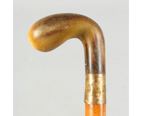 A RHINO HORN HANDLED WALKING STICK, with metal collar.