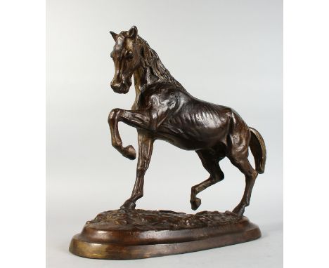 A BRONZE STALLION, on a naturalistic base. 14ins high x 15ins long.