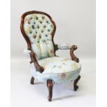 A GOOD VICTORIAN MAHOGANY BUTTONED BACK ARMCHAIR, with floral cover and show wood frame, supported