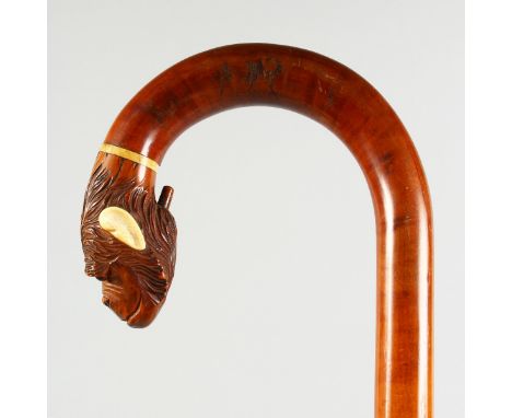 A GOOD WALING STICK, with articulated monkey handle with bone ears. 3ft long.