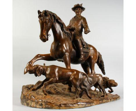 AFTER PIERRE-JULES MENE A SUPERB LARGE BRONZE GROUP, HUNTING, a man on horseback with three hounds. 24ins high x 24ins long.