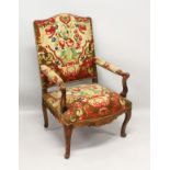 A GOOD 18TH CENTURY FRENCH WALNUT ARMCHAIR, with needlework back, arms and seat, supported on