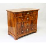 AN 18TH CENTURY CONTINENTAL STRAIGHT FRONT FOUR DRAWER COMMODE with brass handles on bracket feet.