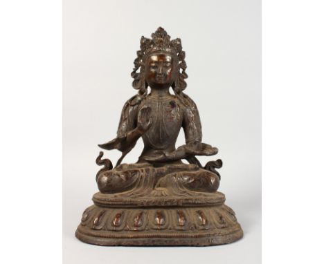 A SEATED BRONZE GOD. 14ins high.