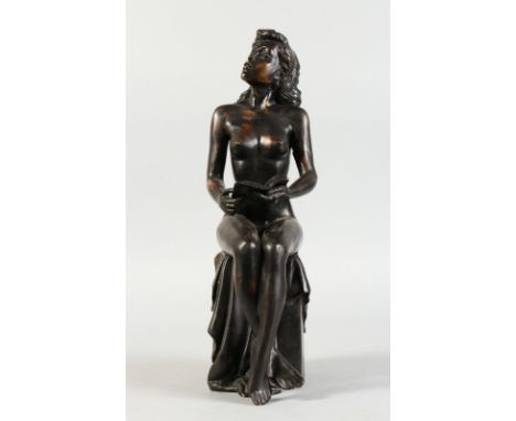 A BRONZE NUDE, sitting on a plinth reading a book. 16ins high.