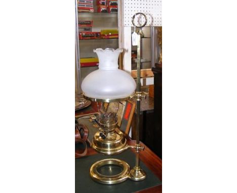 A 65cm high brass students oil lamp with milk glass shade