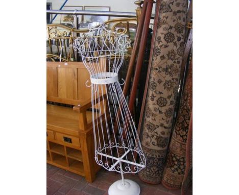 Two old wooden curtain rails together with a white wire mannequin 